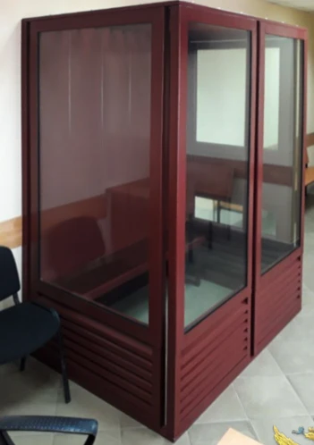 Metal cabin for the defendant in the courtroom. Court furniture