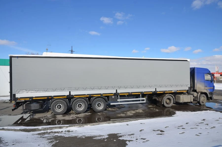 Semitrailer Politrans 94171-0000011. In version: metal platform with decking, with boards, with curtain tent structure.