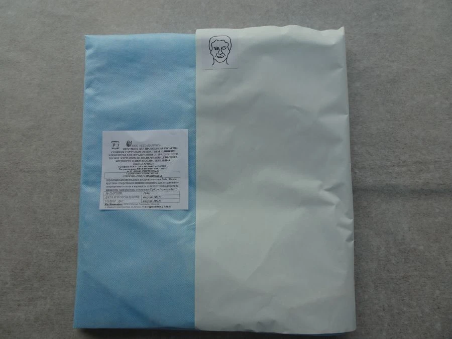 Cesarean section sheet with round opening and adhesive element for limitation of the operating field and pocket and