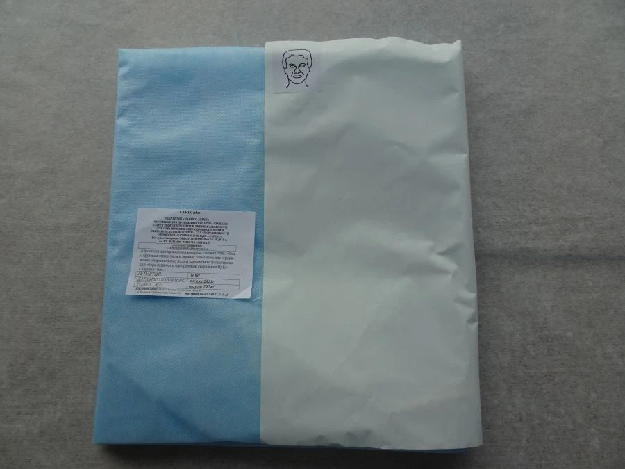 Cesarean section sheet with round opening and adhesive element for limitation of the operating field and pocket and