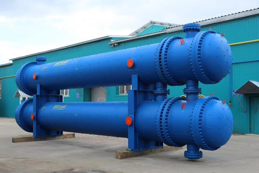 Shell and tube heat exchangers with fixed tube grids and shell and tube heat exchangers with skin temperature compensator