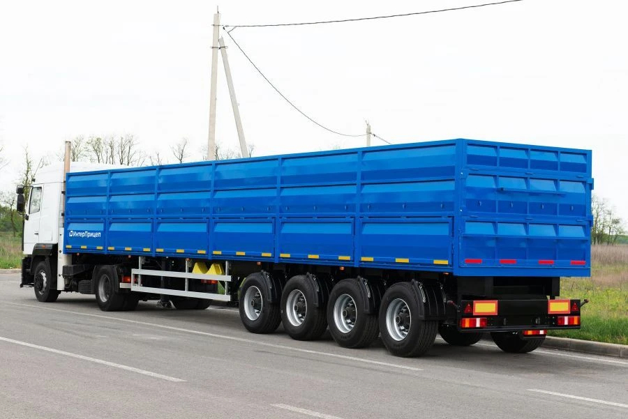 Tipper semi-trailer with side dump body type 85334, modification 853343. Metal tipper body of square cross-section with tipping.