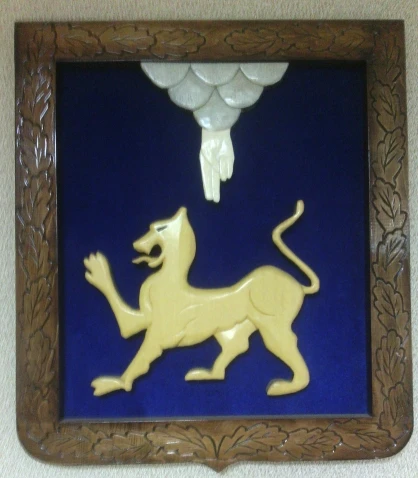 Coat of arms of the city of Pskov carved in wood with velvet trimming