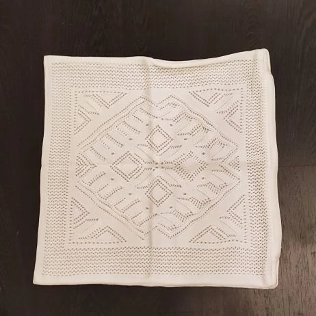 Decorative decorative pillowcase knitted by machine from blended, synthetic yarn.