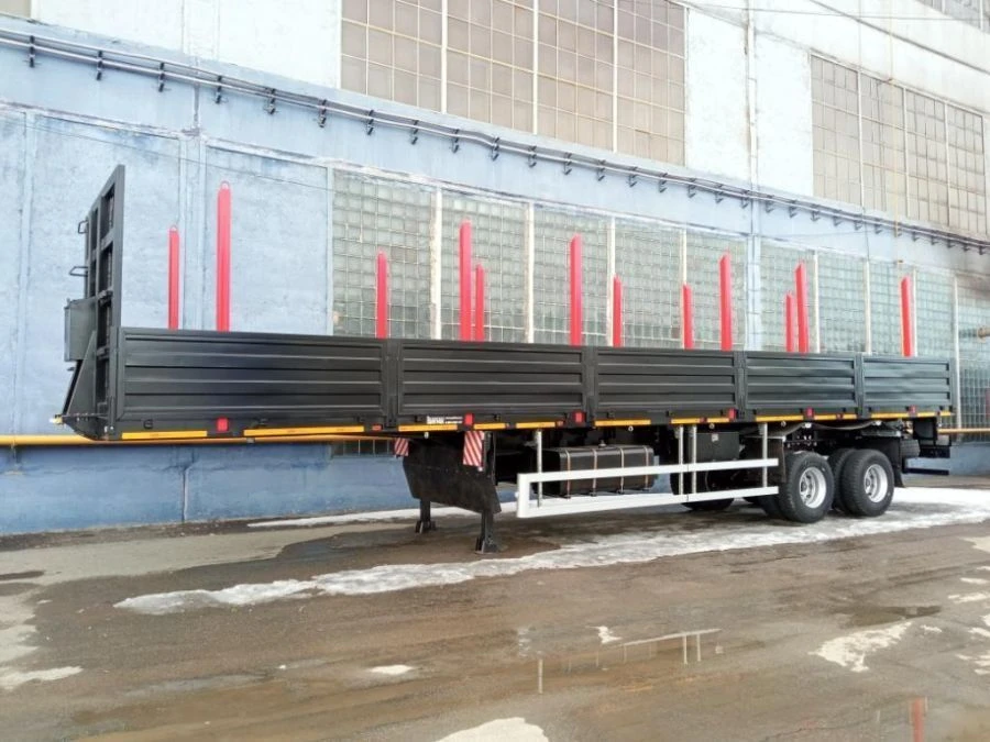 Semitrailer Politrans 9417-050. In the version: metal platform with decking, with sides, with racks (cones), with devices.