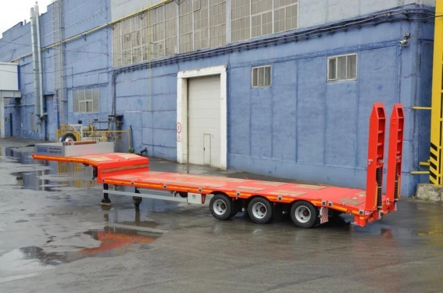 Semitrailer-heavy hauler Politrans 94183-030. In the version: metal platform with a loading platform, with ladders, with flatbed