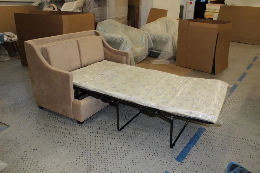 Sofa on metal frame with folding mechanism.
