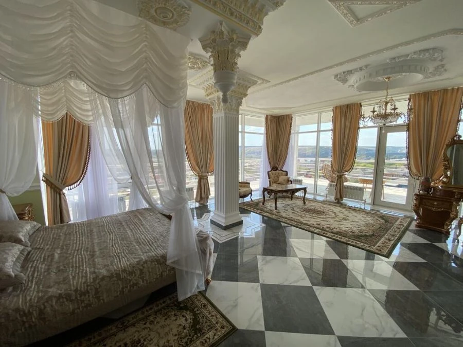 Curtains (including drapes) and inner curtains; lambrequins and bedspreads made of synthetic yarns.