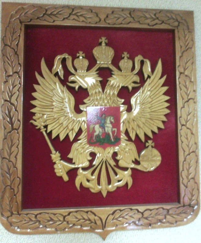 Coat of arms of the Russian Federation carved of wood with velvet trimming