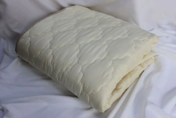 Quilted blankets with a top made of natural, blended, synthetic fabrics with a filler made of natural, blended, synthetic fibre.
