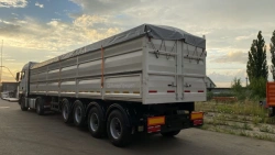 Semi-trailer grain carrier type 85339, modification 853391. Metal flatbed platform with a front fixed side, with folding sides a