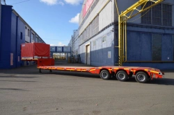 Semitrailer Politrans 94183-010. In the version: metal platform with lowered load platform, with detachable front load box, with