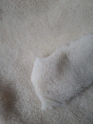 Artificial knitted fur with pile of woolen and synthetic fibres