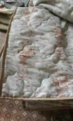Quilted blanket made of blended fabrics filled with synthetic material