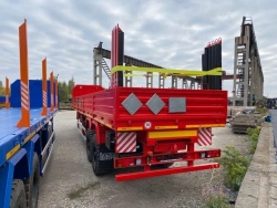 Semitrailer Politrans 9417-011. In the version: metal platform with decking, with sides, with stands (cones), with modulator.