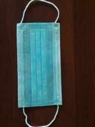 Medical non-sterile disposable mask made of nonwoven materials, three-layered