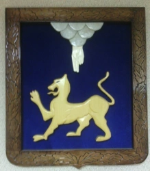 Coat of arms of the city of Pskov carved in wood with velvet trimming