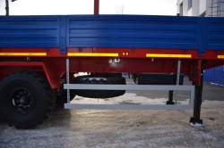 Semitrailer Politrans 94171-026. In the version: metal platform with decking, with pneumatic suspension. Axles manufactured by "