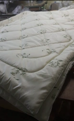 Quilted blanket of cotton fabrics filled with hollofiber filling