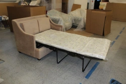 Sofa on metal frame with folding mechanism.