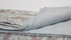 Quilted coverlets with a top made of natural, blended, synthetic fabrics filled with natural, blended, synthetic fibres.